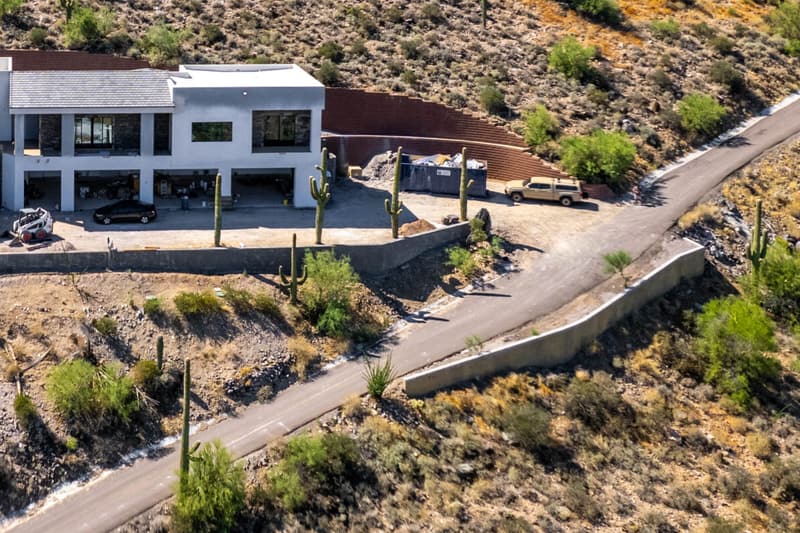 Concrete retaining walls along the pad and driveway of a hillside home on a Diamond West project in Arizona