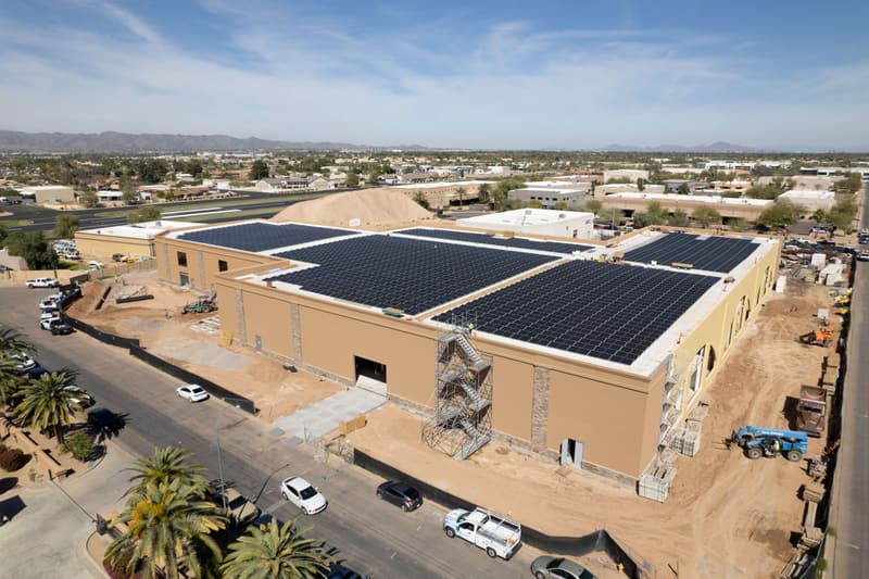 Aerial view of site grading around a commercial building with rooftop solar on a Diamond West project in Arizona